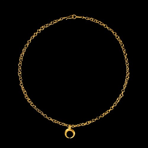 A Roman gold necklace with crescent-shaped pendant.